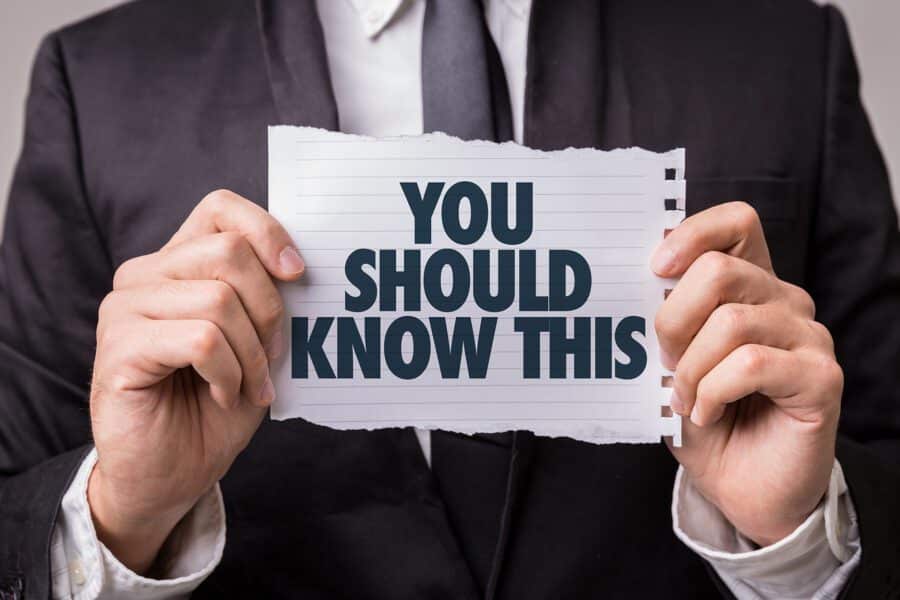 The man is holding a quote " you should know this" on paper